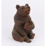 Late 19th century Black Forest carved tobacco jar music box formed as a seated bear,