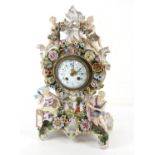 Dresden floral encrusted mantel clock, applied with figures and painted with children playing,