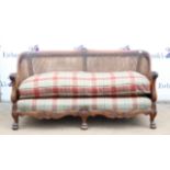 Mahogany double caned three piece bergere suite, comprising a two seat settee and two armchairs,