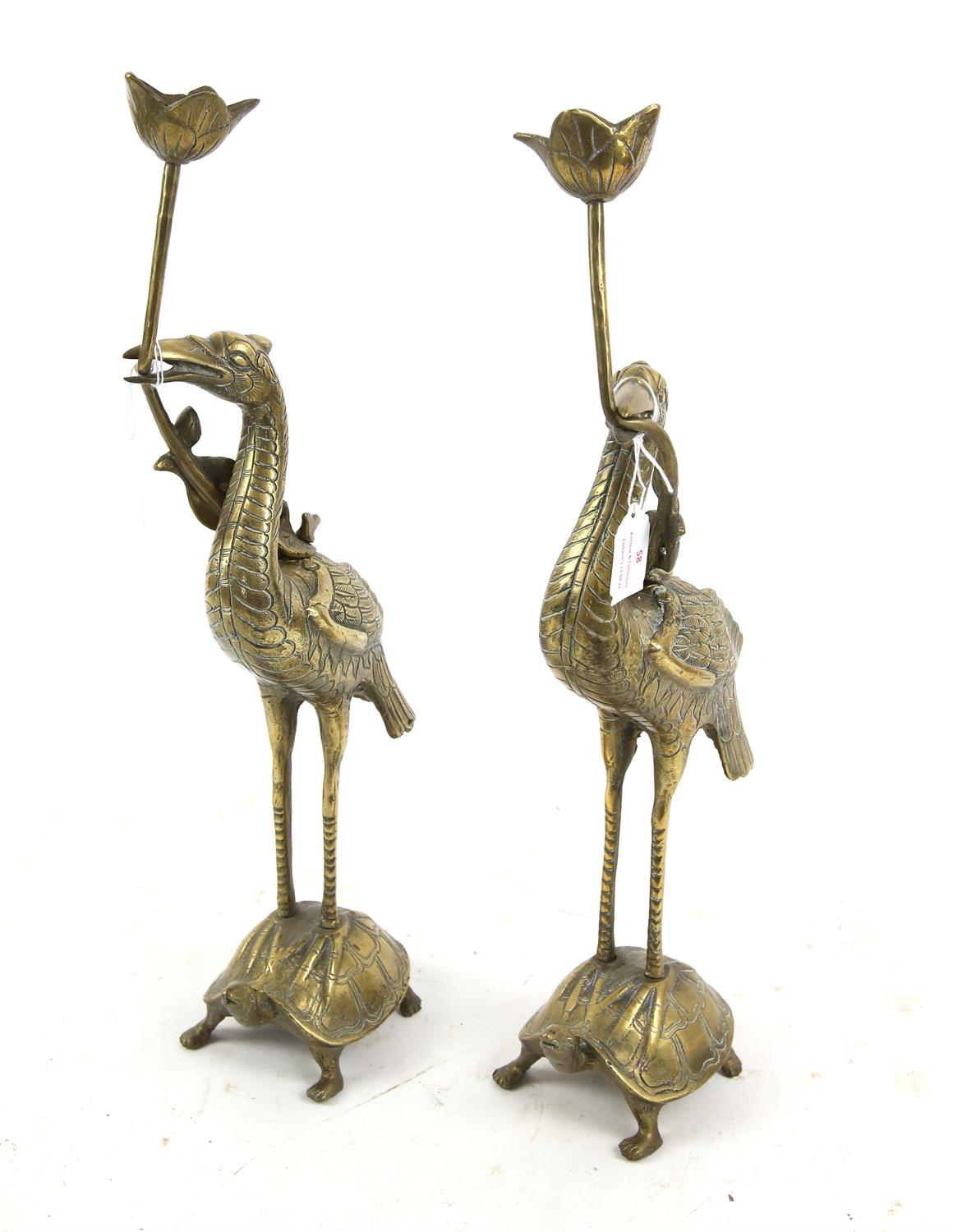 Pair of Chinese brass candleholders in the form of herons standing on the backs of turtles, 47.