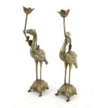 Pair of Chinese brass candleholders in the form of herons standing on the backs of turtles, 47.