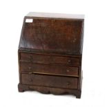 Miniature oak George III style bureau, the sloping fall enclosing an empty interior over three