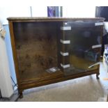 20th century mahogany bookcase with carved decoration, sliding glass doors on squat carved cabriole