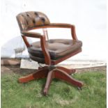 Button back leather swivel armchair, with padded seat and castors