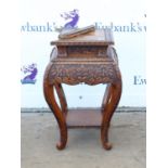 Oriental hardwood jardiniere stand, the square top over a bulbous foliate carved frieze on leaf