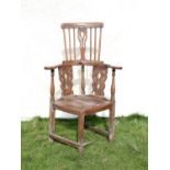 George III elm corner Windsor type chair, the spindle and pierced splat back with turned arm