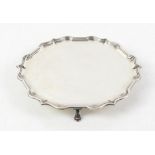 Modern silver salver with Chippendale style border supported on three pad feet, by C J Vander Ltd,