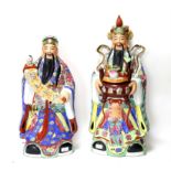 Large Chinese ceramic figures, including one a bowl of fruit and another holding a child and sash,