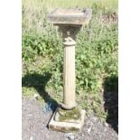 Reconstituted stone bird bath, the square top on a stop fluted Corinthian column and stepped base,