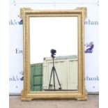 20th century rectangular gilt framed mirror with moulded scrolling foliate corners,127 x 91 cm