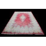 Large Kerman carpet, the floral medallion and border on a rose colour field, 514 x 284 cm