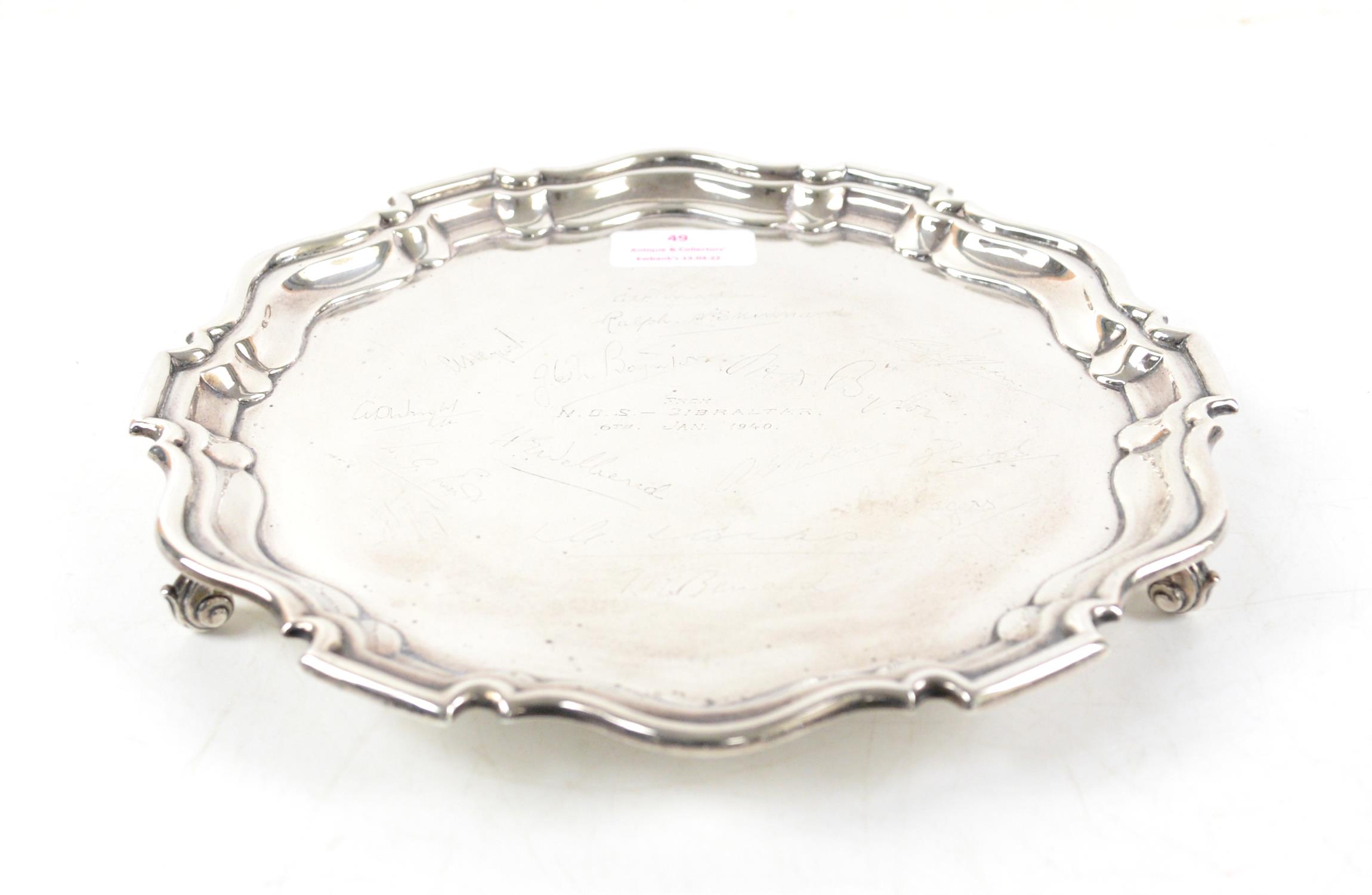 Silver salver, with pie-crust edge and three scroll feet, engraved with signatures and inscribed