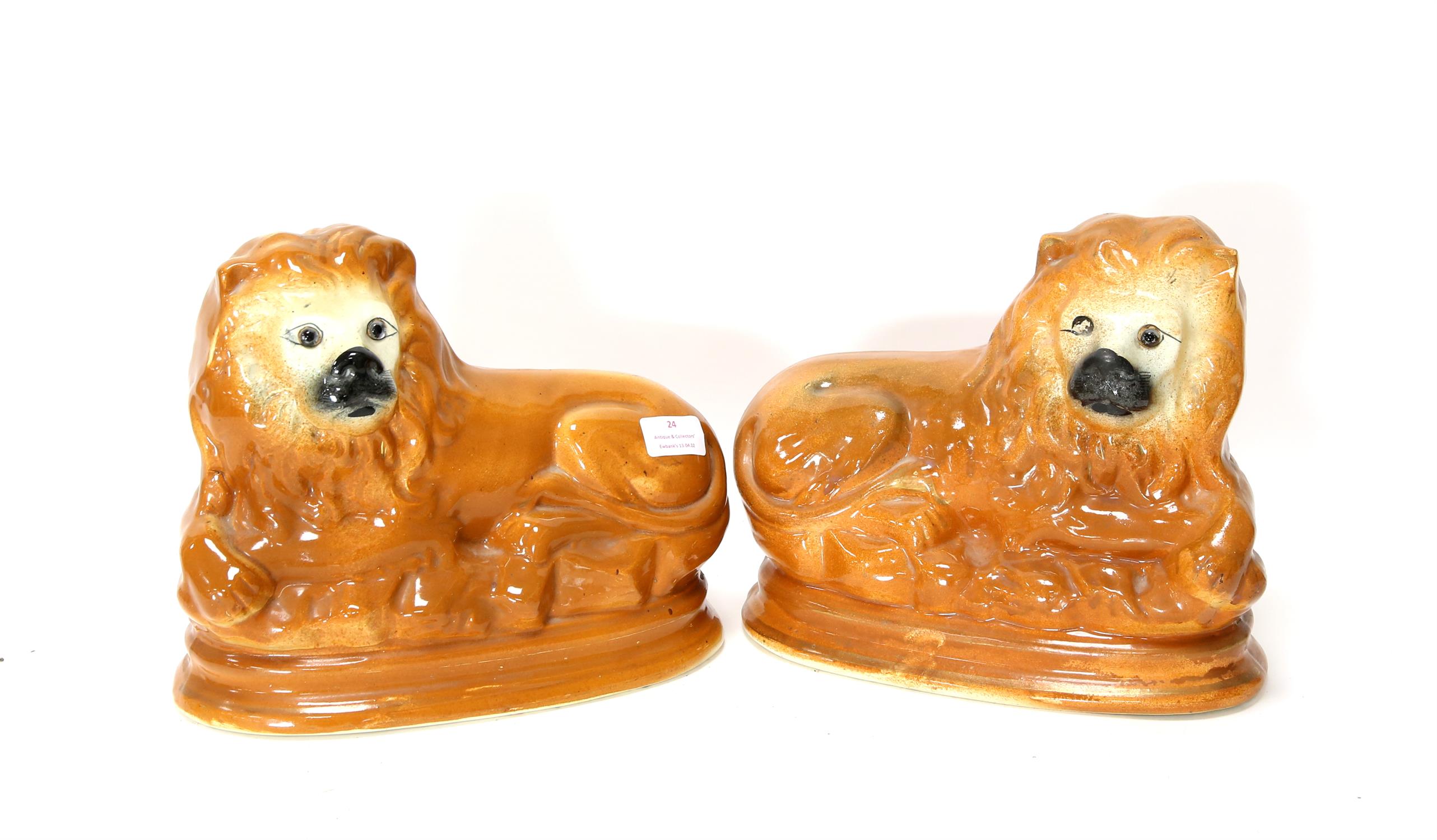 Pair of Victorian Staffordshire figures of seated lions, H23 cm