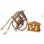 Wooden model chalet and two pull along dolls carriages,