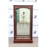 Mahogany display cabinet, with arched glass door, enclosing glass shelves and mirror back,