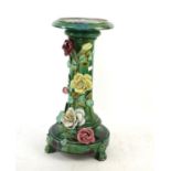 Continental pottery jardiniere on stand with applied floral decoration,