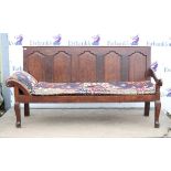 Early 19th century oak settle, the five ogee panelled back over a loose cushion seat with head rest