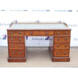Victorian mahogany pedestal desk, the leather inset top with three quarter brass gallery over three