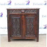 Victorian carved oak side cabinet, the foliate and mask carved frieze drawer over a pair of lozenge