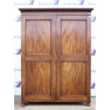 Mahogany wardrobe, with moulded cornice and twin panelled doors on turned feet, H193 W147 D58 cm