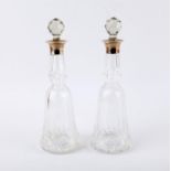 Pair of cut glass bottles and stoppers, with silver collars, London 1924 Mappin & Webb,