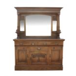 Art Nouveau mirrored back oak sideboard, with bevelled glass plates flanked by floral carved panels