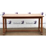 Arts and Crafts oak dining table, the rectangular top over arched end frieze, on square section