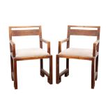 Pair of 1930s oak open armchairs, of angular form with solid seats (later pads), on square legs,