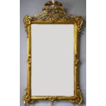 Victorian Art Nouveau style giltwood wall mirror, the rectangular bevelled plate with an open