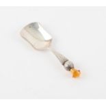 Thistle form caddy spoon set with amber coloured stone by WJS Birmingham 1902