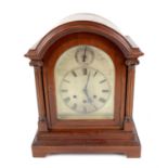 Early 20th century mahogany bracket clock, the arched case with fluted columns enclosing a silvered