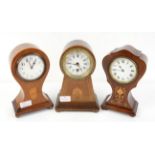 Three early 20th century inlaid mahogany balloon shape table timepiece clocks, tallest 25 cm high,