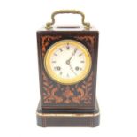 French late 19th century inlaid travel clock, the brass handle over a foliate design enclosing an