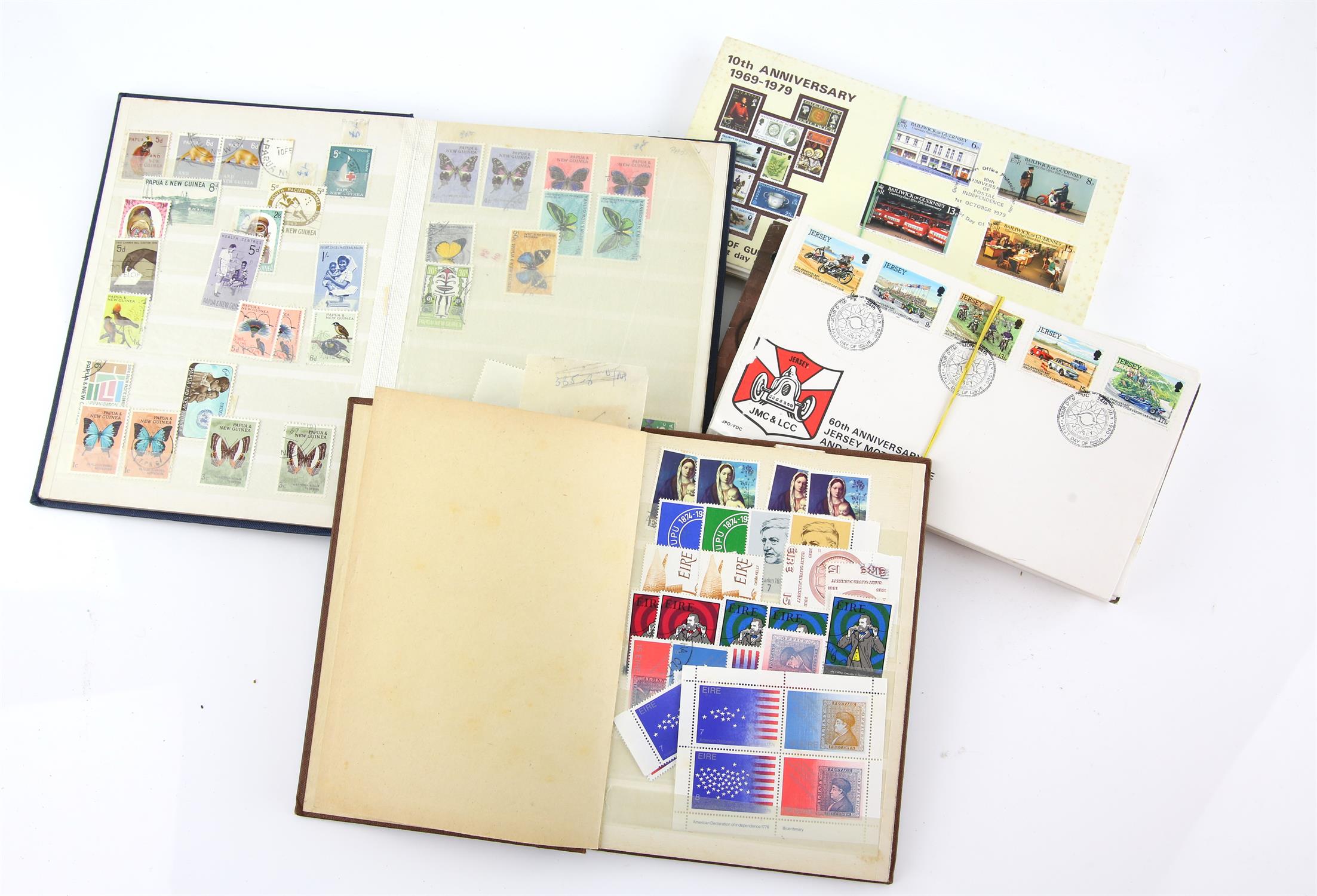 Two small stock books, Ireland and Papua New Gunea, loose First Day Covers including 1965 Battle of