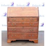 19th century oak bureau with fall flap enclosing cupboard and pigeon holes, over four long drawers