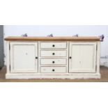 Painted pine sideboard, with four central drawers flanked by cupboard doors on a plinth base,