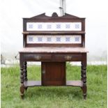 Early 20th century mahogany wash stand with two central drawers and brown marble top with tiled