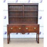 Oak dresser and rack, the burr walnut frieze over two shelves on a base with two walnut veneered