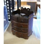 Miniature Victorian bowfront chest of drawers, with fret carved raised back, H24.5 W17.5 D11 cm