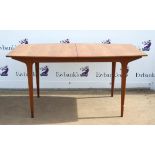 1960s McIntosh Furniture teak dining table, the rounded rectangular top enclosing an extra leaf,