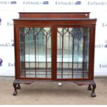 Mahogany bowfront display cabinet, the raised back over gadrooned edge and a pair of glazed doors