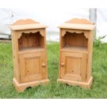 A pair of pine bedside cupboards