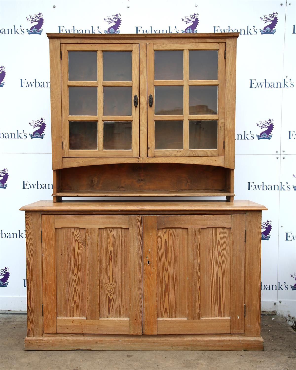 20th century pine dresser base on plinth base, the light oak upper section with glazed cupboards