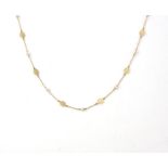 Seed pearl necklace, nine seed pearls each separated by links and floral design discs,