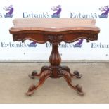 Victorian rosewood foldover card table, the shaped hinged top on a reeded baluster stem and carved