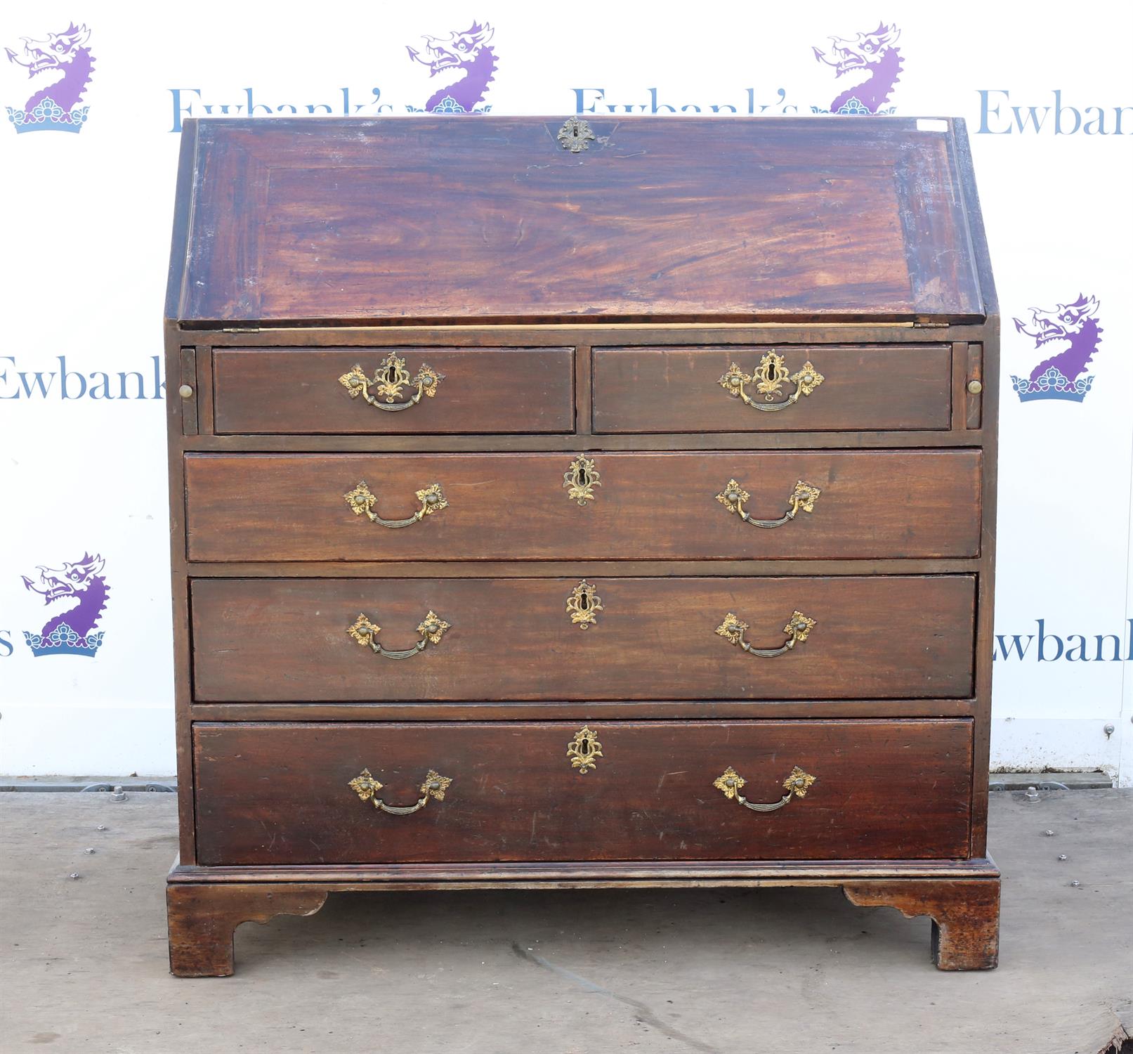 George III mahogany bureau, the sloping fall front enclosing pigeon holes and drawers over two