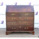 George III mahogany bureau, the sloping fall front enclosing pigeon holes and drawers over two