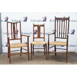 Two oak framed elbow chairs with rushed seats and a similar side chair