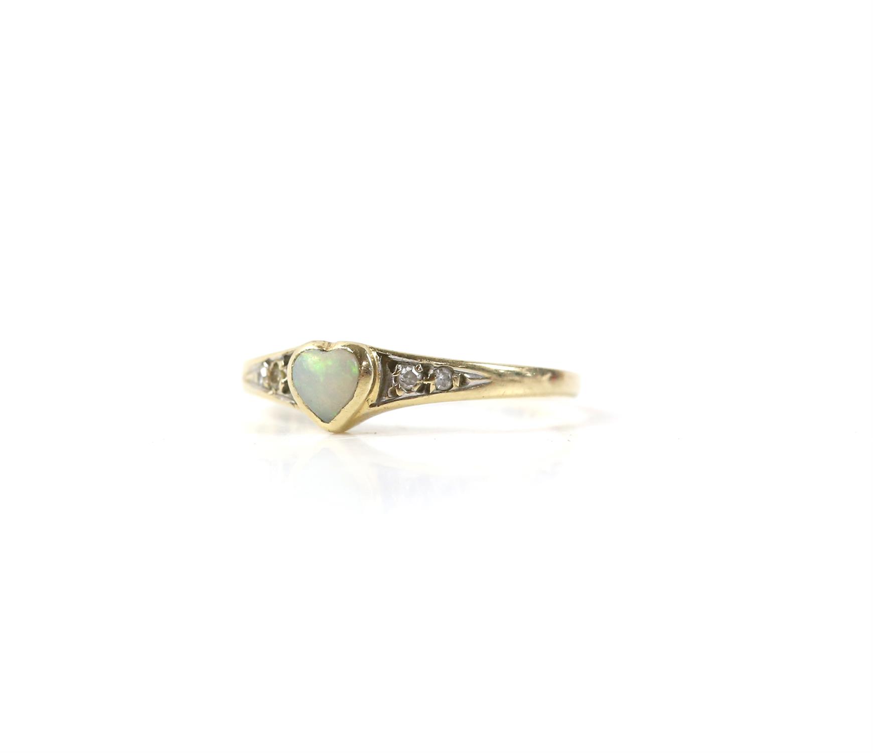 Opal ring, heart shaped opal rubover set in 9 ct yellow gold, with diamond set shoulders,