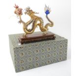 Gilt metal sculpture of a dragon, (in fitted case),